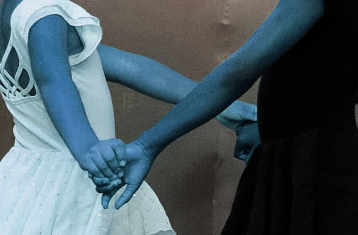 Hands holding together, symbolising care and connection